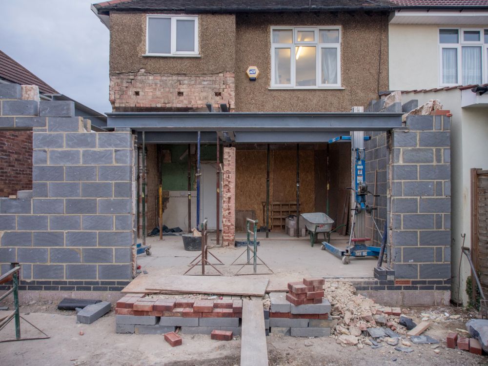 A small house undergoing refurbishment, with structural building work in progress
